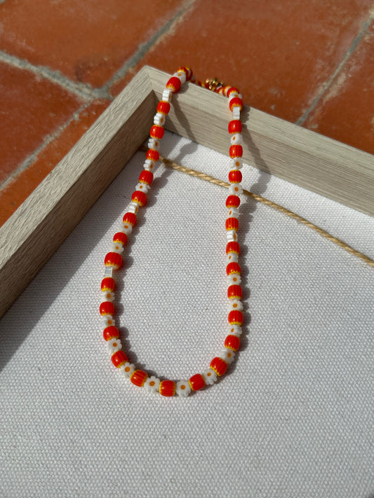 Collar hecho a mano con margaritas y cuentas de cerámica en tonos naranja y amarillo. Con cierre ajustable en acero inoxidable